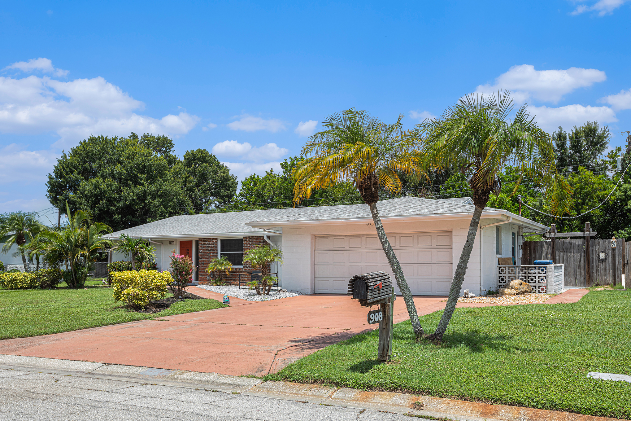 Front exterior with palms